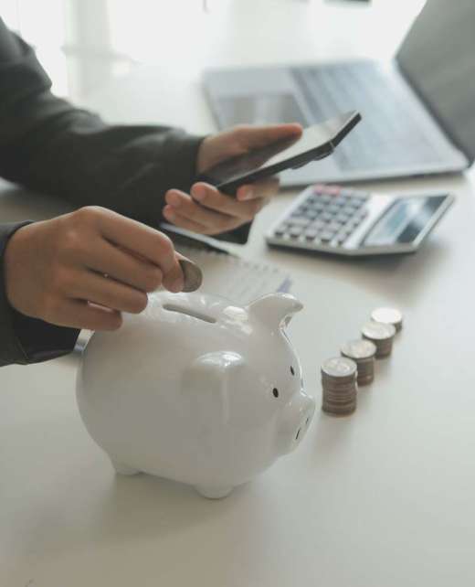 saving money and accounting concept. business man putting coin insert to jar and make acounting book for finance management to investment and saving.