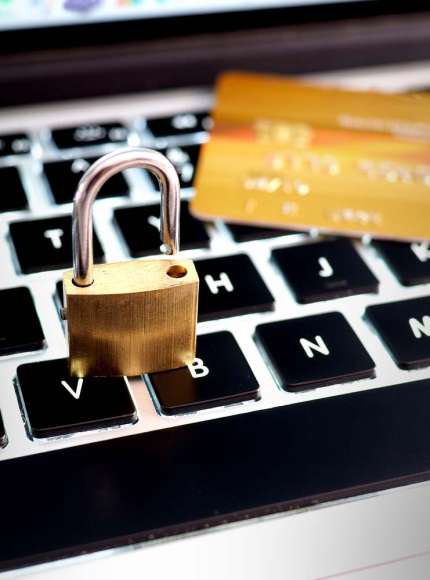 Credit card and lock on computer keyboard