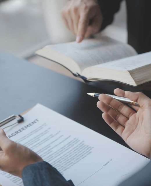 Justice and law concept.Male judge in a courtroom with the gavel, working with, computer and docking keyboard, eyeglasses, on table in morning light